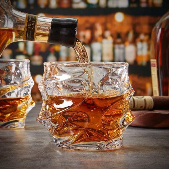 Sculpted whiskey glass with whiskey poured in